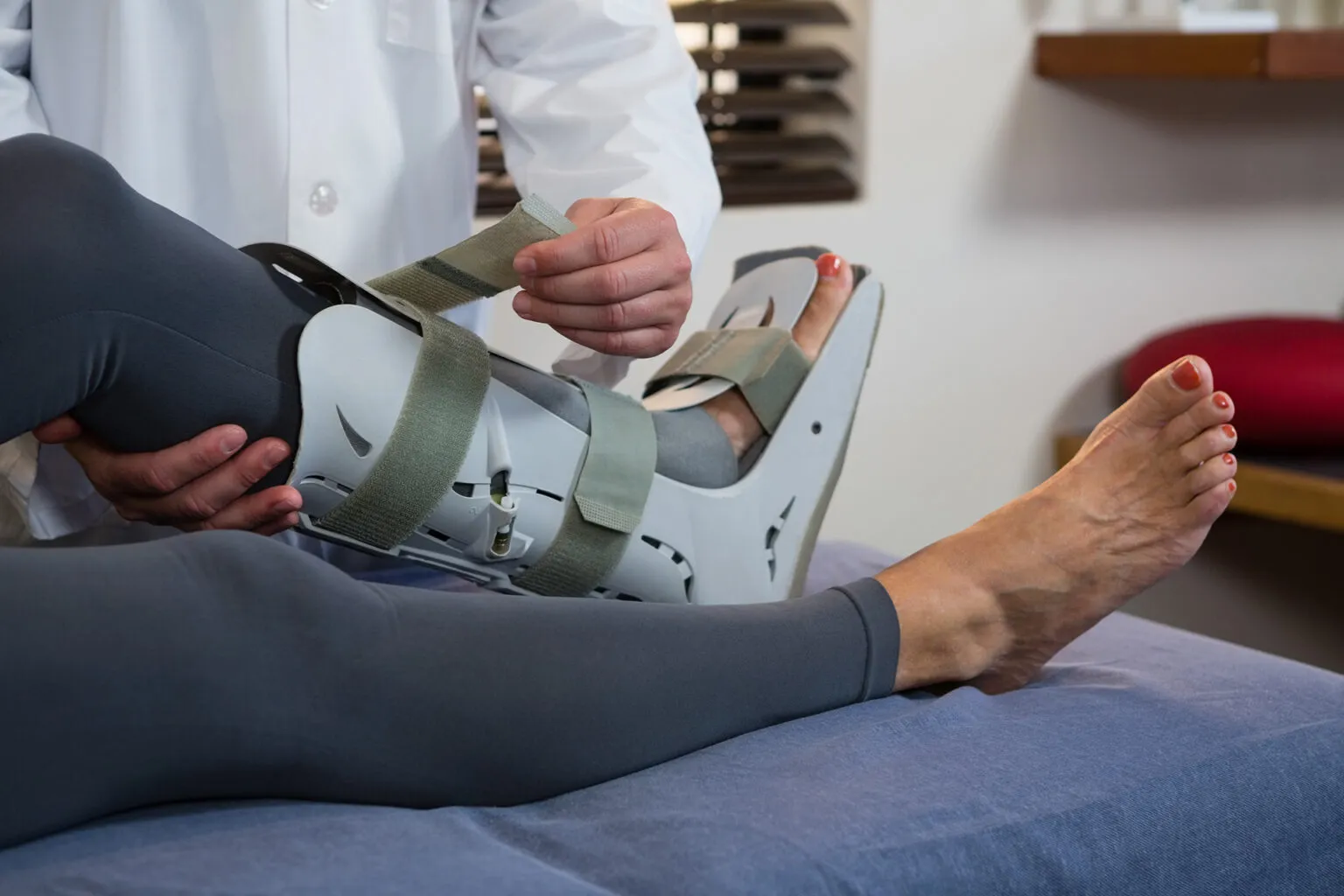 Clinician fitting a brace on an injured leg after a fall
