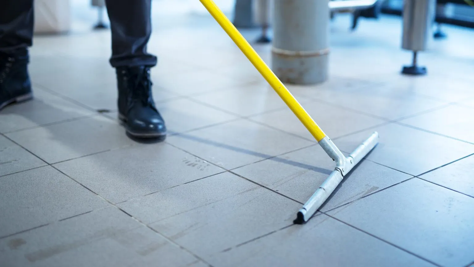 Wet floor being cleaned in a public building