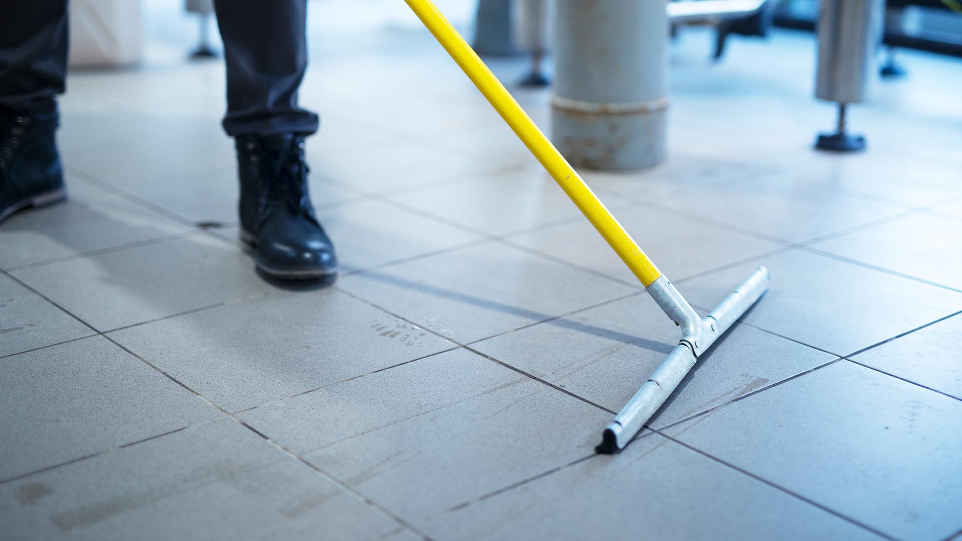 person mopping wet floor