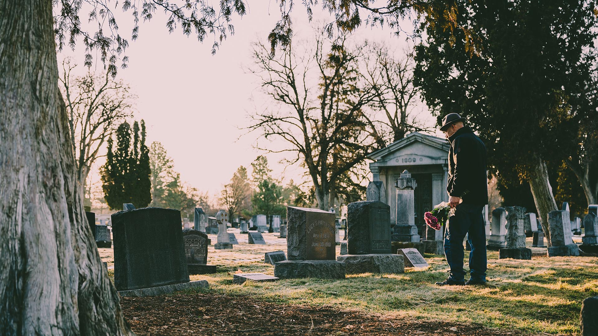 person looking over grave