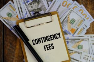Contingency Fees written on paper and dollar in background