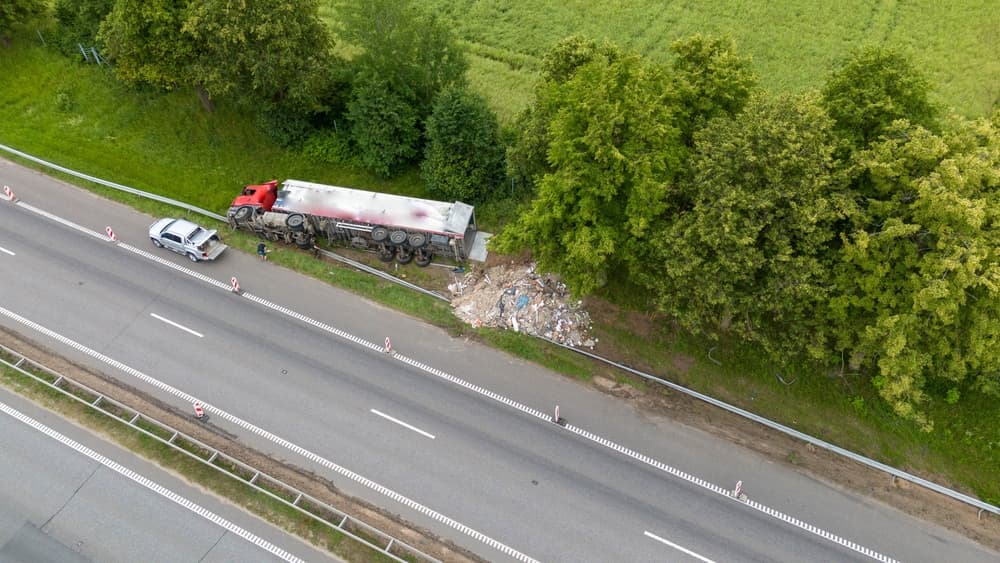 An aerial view of a truck accident scene on a highway.