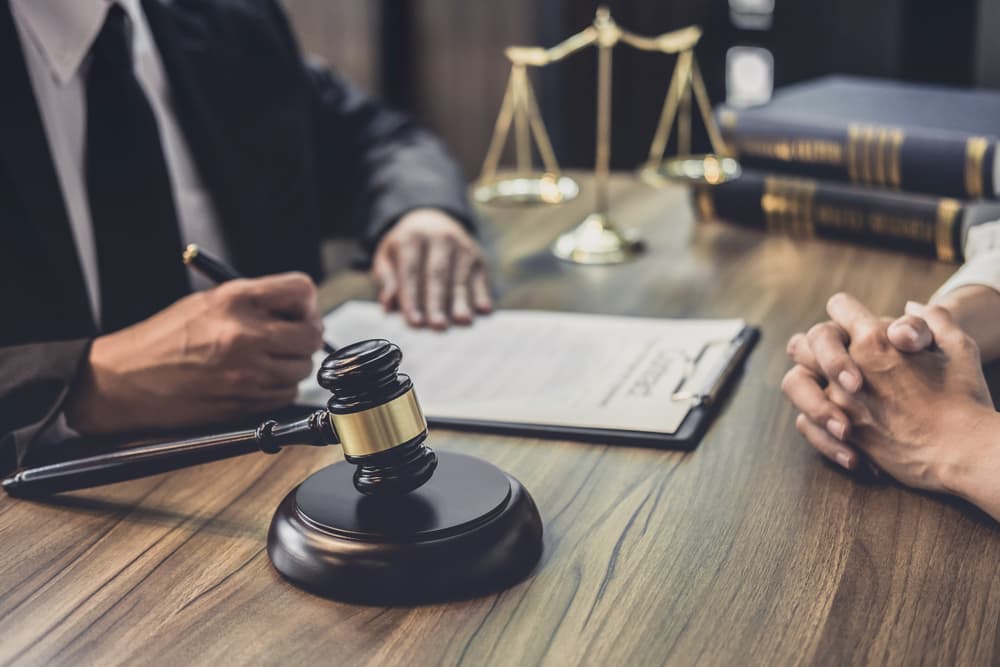 Chicago Lawyer Consultation for I-290 Eisenhower Expressway Accident Claim Client discussing an I-290 Eisenhower Expressway accident claim with a Chicago personal injury lawyer, shown with legal documents, gavel, and scales of justice.