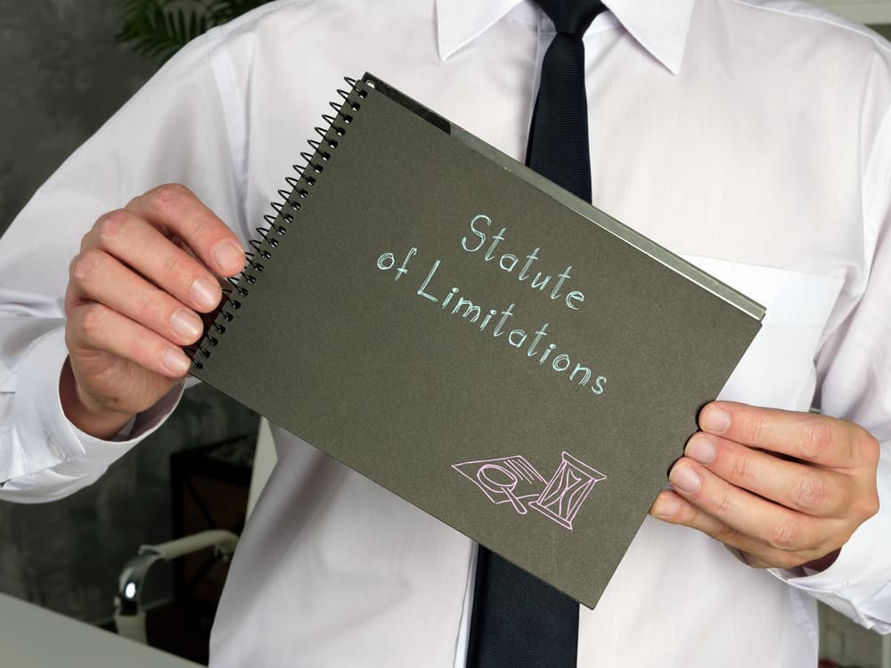 Illinois Wrongful Death Statute of Limitations Explained Person holding a Statute of Limitations notebook representing Illinois wrongful death claim filing deadlines.